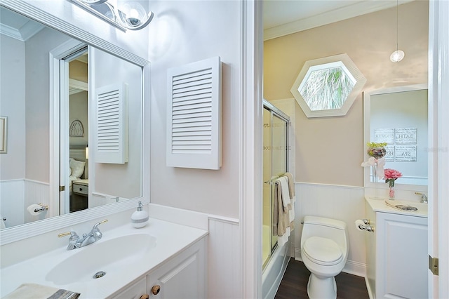 full bathroom with vanity, toilet, enclosed tub / shower combo, and crown molding