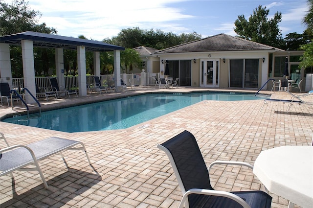 view of swimming pool featuring an outdoor structure and a patio