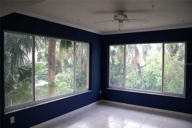 unfurnished room featuring ceiling fan, light tile patterned flooring, crown molding, and plenty of natural light