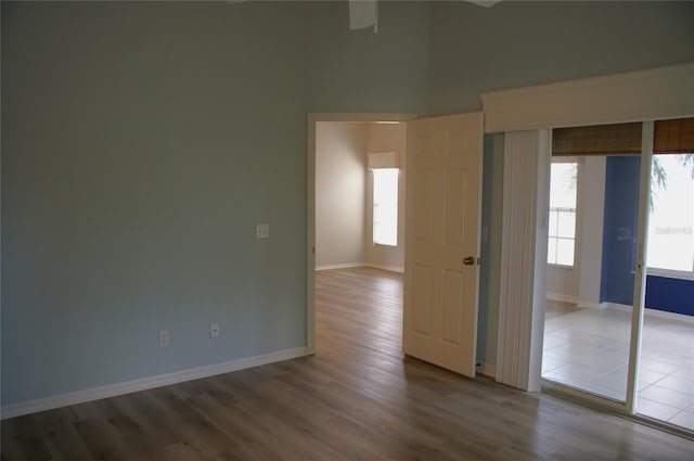 spare room featuring a healthy amount of sunlight and hardwood / wood-style flooring