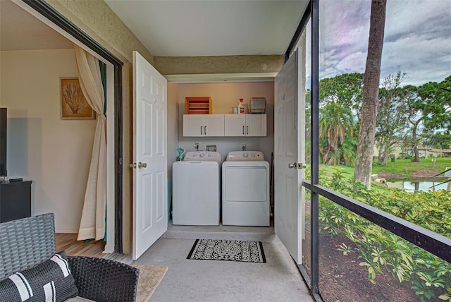 washroom featuring cabinets and separate washer and dryer