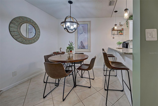 dining room featuring light tile patterned floors, a textured ceiling, and a notable chandelier