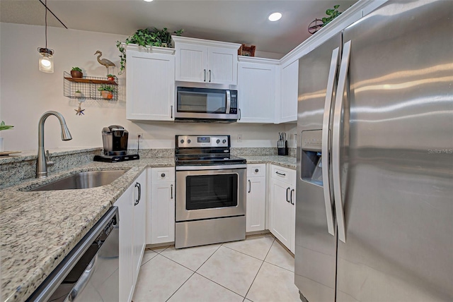 kitchen with pendant lighting, sink, white cabinetry, and stainless steel appliances