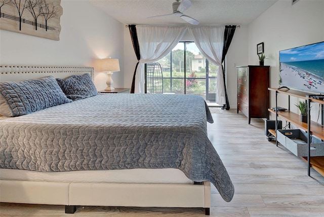 bedroom featuring ceiling fan, light hardwood / wood-style floors, and a textured ceiling