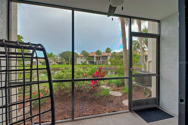 unfurnished sunroom featuring a water view