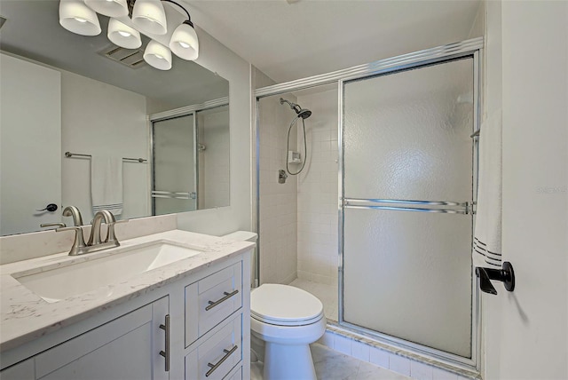 bathroom with toilet, vanity, and walk in shower