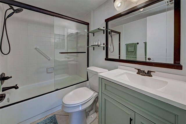 full bathroom with tile patterned flooring, vanity, toilet, and combined bath / shower with glass door