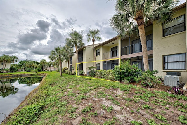 exterior space featuring a water view and central AC unit