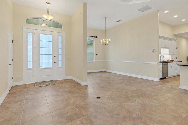 entryway with visible vents, baseboards, light tile patterned floors, recessed lighting, and an inviting chandelier