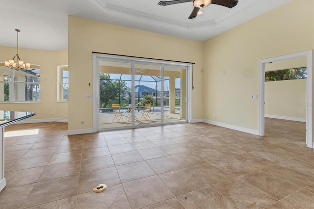 unfurnished room featuring ceiling fan with notable chandelier, a raised ceiling, crown molding, and baseboards