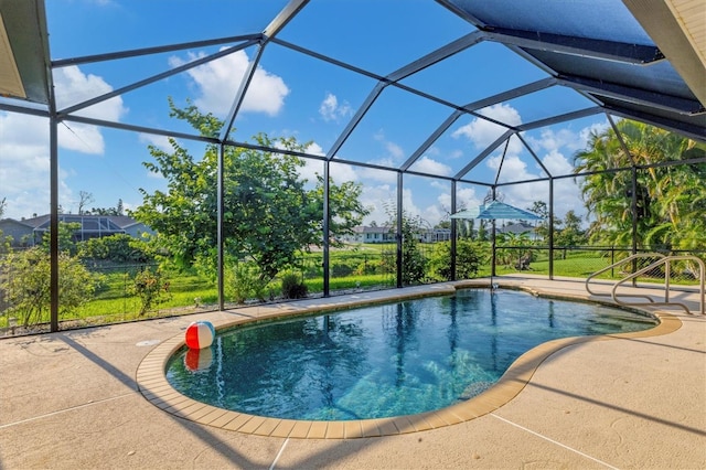 pool featuring glass enclosure and a patio