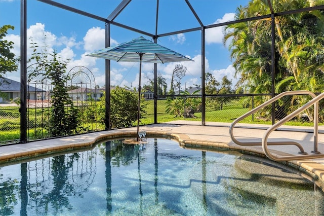 view of swimming pool featuring glass enclosure