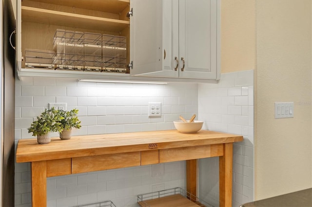 kitchen featuring backsplash and wooden counters