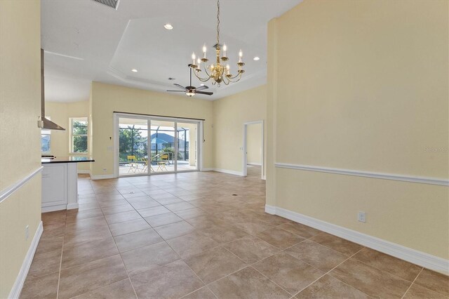 interior space featuring recessed lighting, a tray ceiling, baseboards, and light tile patterned floors