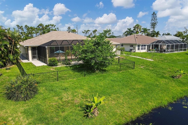 view of yard with glass enclosure and a fenced backyard