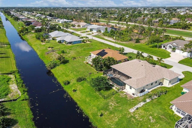 drone / aerial view with a residential view and a water view