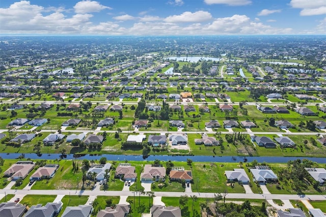 birds eye view of property featuring a residential view and a water view