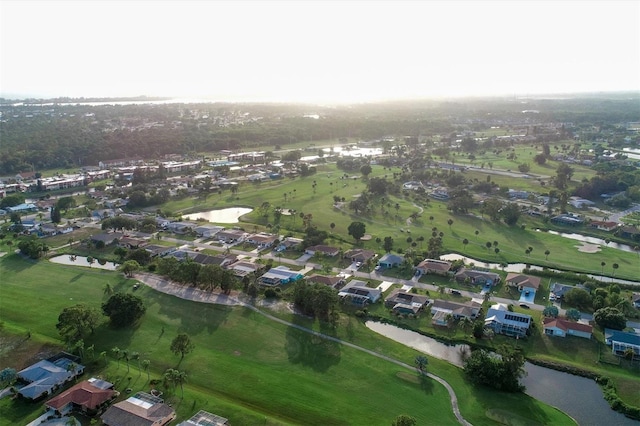 aerial view with a residential view, view of golf course, and a water view