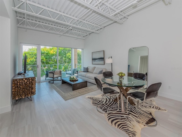 living room featuring a towering ceiling