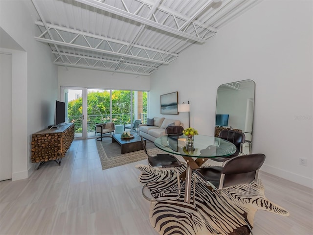 dining area featuring a towering ceiling