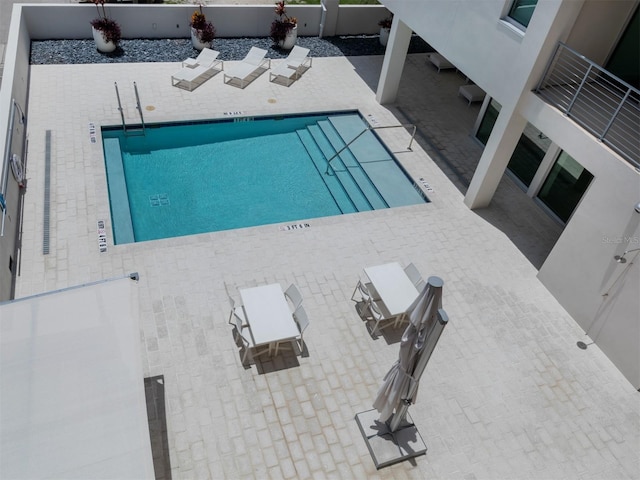 view of swimming pool with a patio