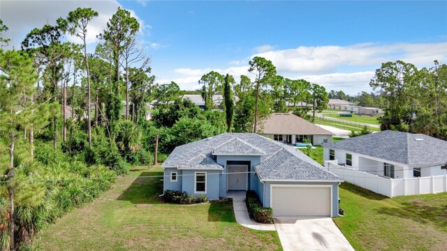 view of front of home with a garage and a front lawn