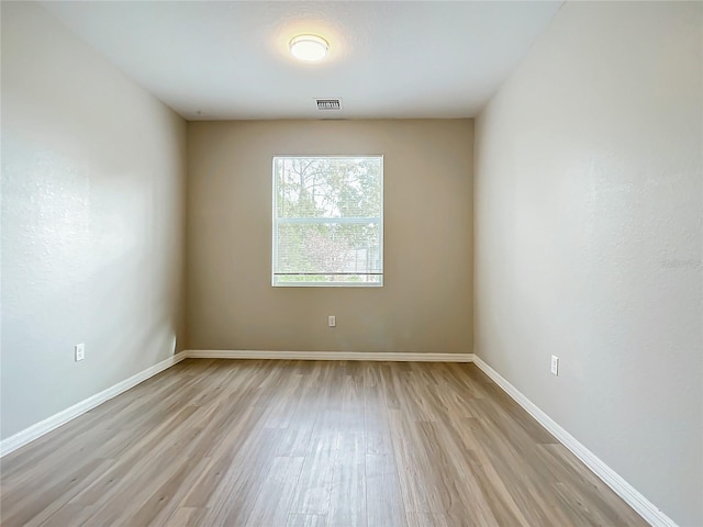 spare room featuring light hardwood / wood-style flooring