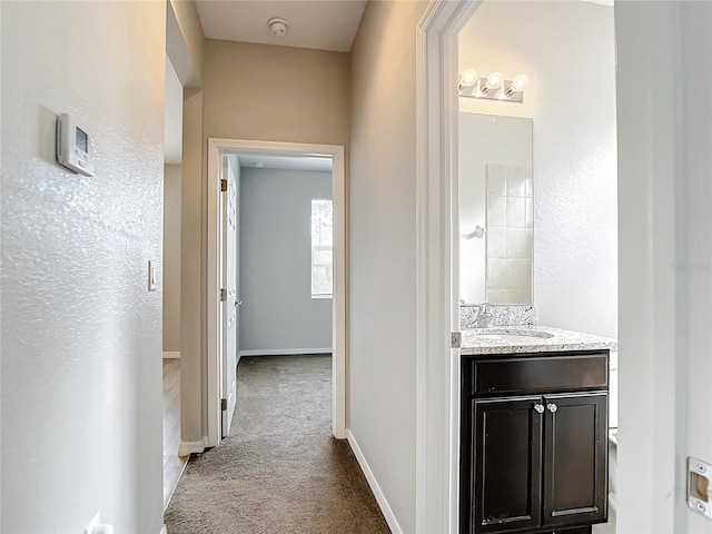 hall featuring carpet and sink