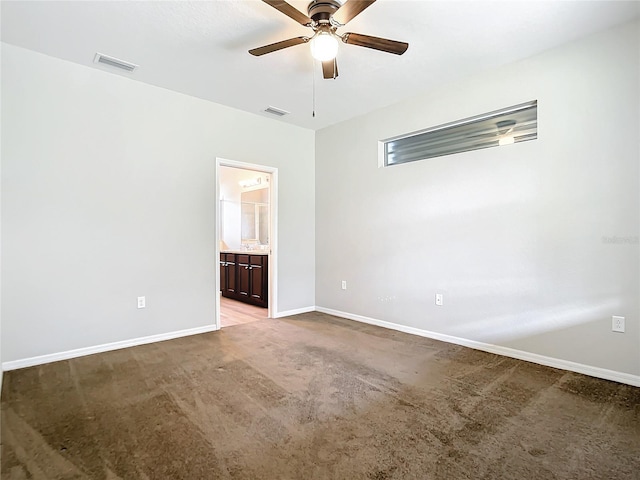 spare room with ceiling fan and light colored carpet