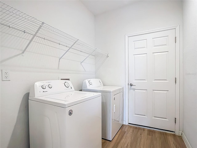 washroom with light wood-type flooring and separate washer and dryer