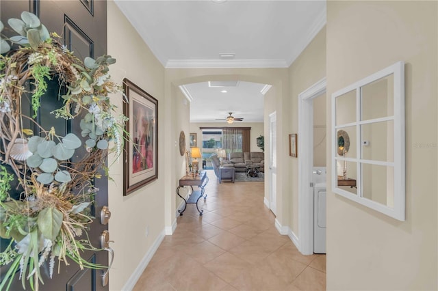 corridor with crown molding and light tile patterned floors