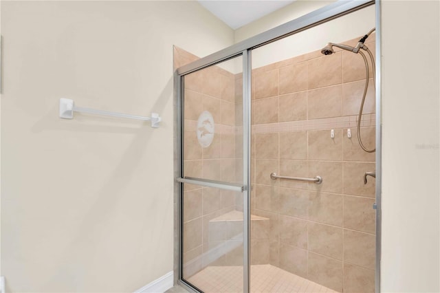 bathroom featuring a shower with shower door