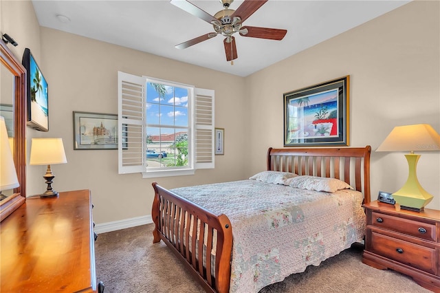 carpeted bedroom with ceiling fan and baseboards