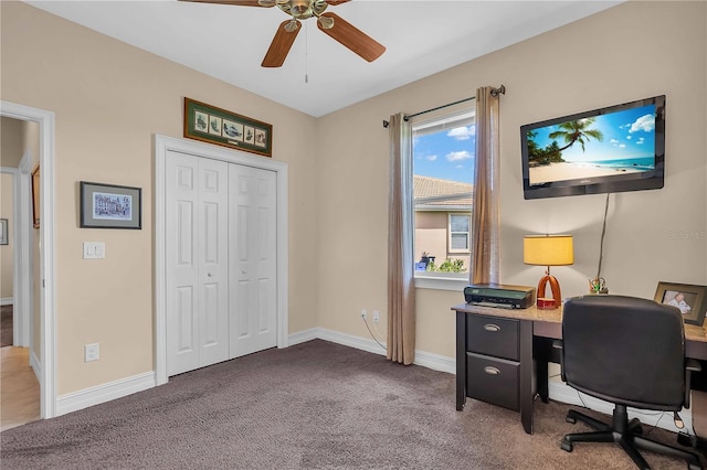 carpeted home office featuring ceiling fan