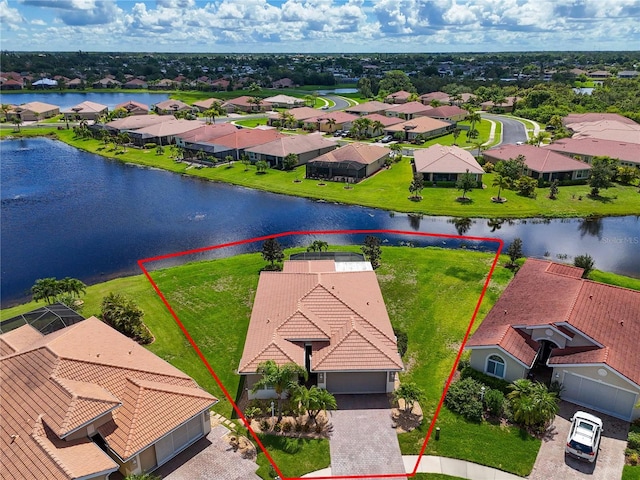 drone / aerial view featuring a residential view and a water view