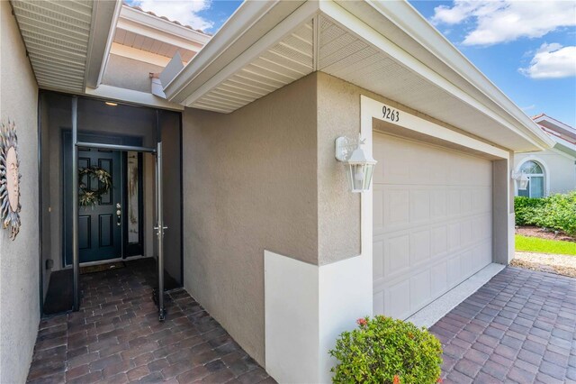 view of exterior entry featuring a garage