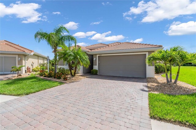 view of front of property with a front lawn and a garage