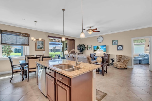 kitchen with decorative light fixtures, an island with sink, sink, stainless steel dishwasher, and a healthy amount of sunlight