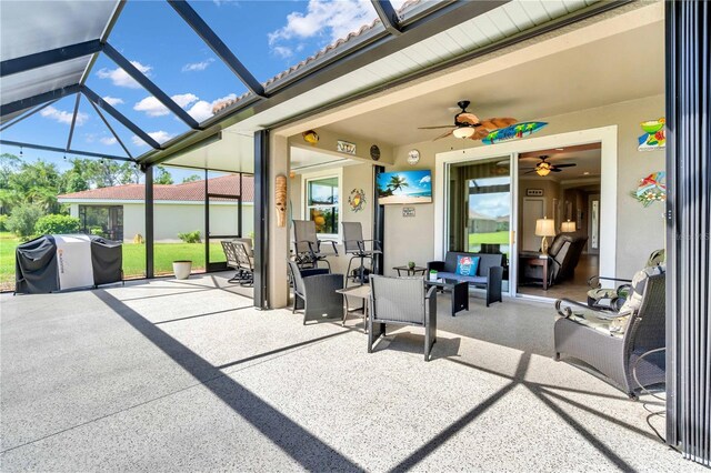 view of patio / terrace with grilling area, glass enclosure, and a ceiling fan