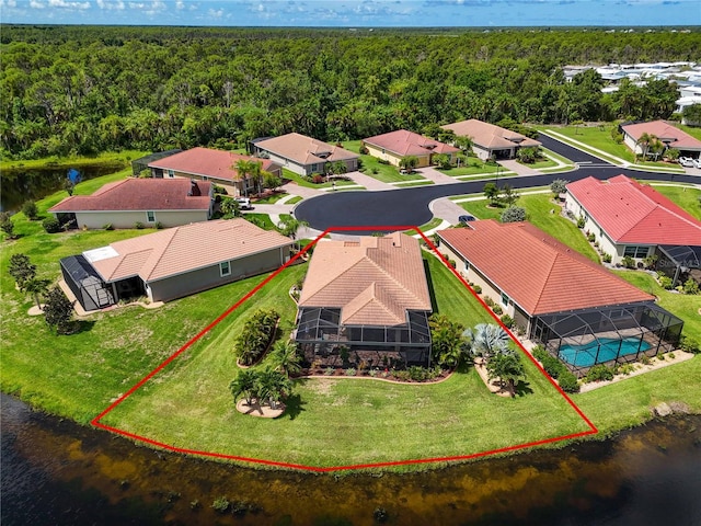 birds eye view of property featuring a residential view, a view of trees, and a water view