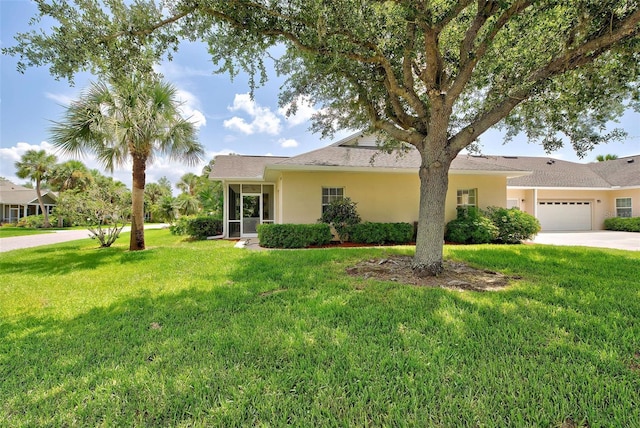 single story home featuring a garage and a front lawn