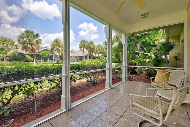 unfurnished sunroom with ceiling fan