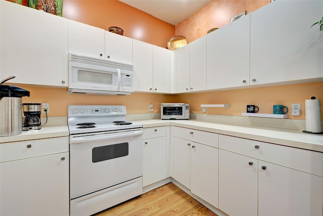 kitchen featuring white cabinetry, white appliances, and light hardwood / wood-style flooring