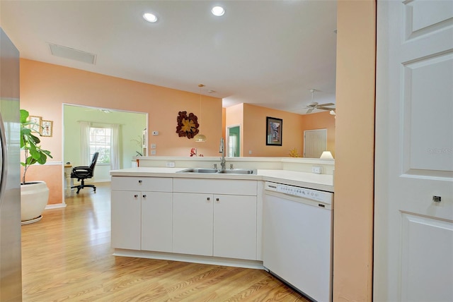 kitchen with sink, white cabinets, ceiling fan, white dishwasher, and light hardwood / wood-style flooring