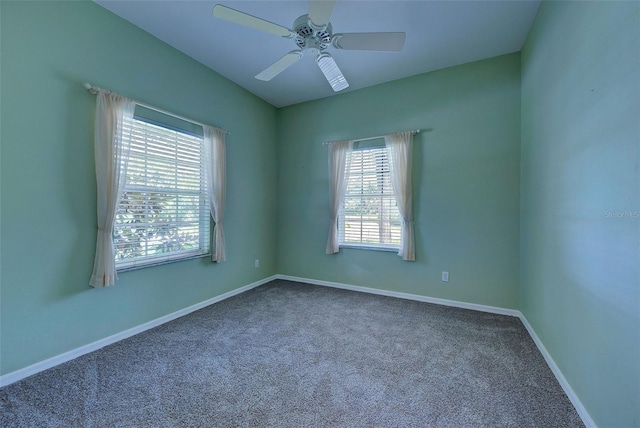 carpeted spare room featuring ceiling fan