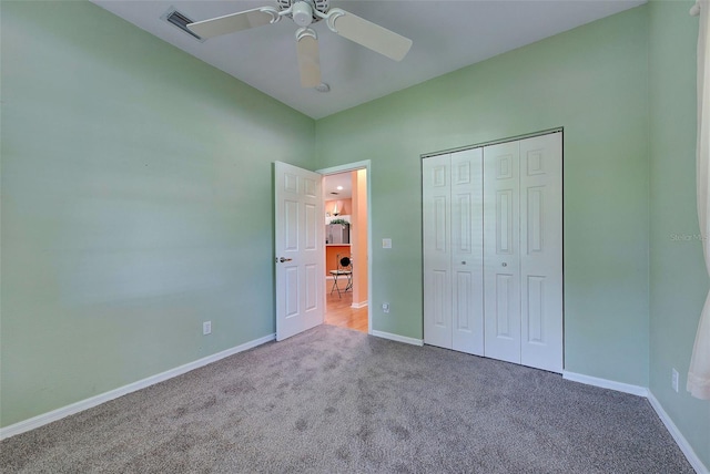 unfurnished bedroom featuring a closet, ceiling fan, and carpet flooring