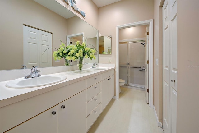 bathroom featuring walk in shower, vanity, and toilet