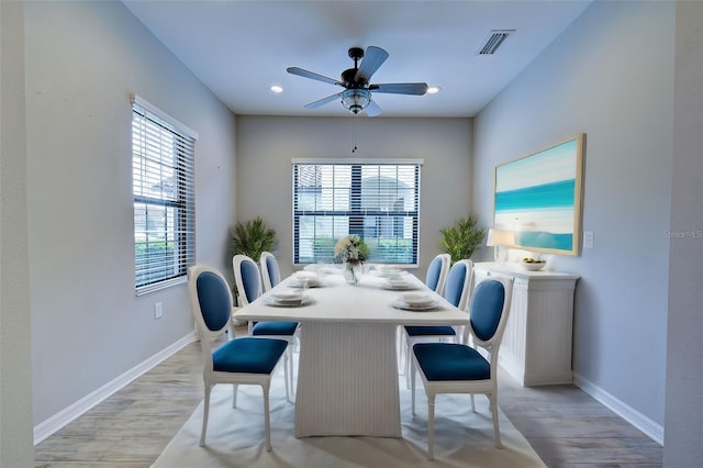 dining space with ceiling fan and light hardwood / wood-style floors