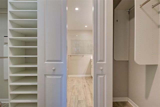 spacious closet featuring hardwood / wood-style flooring