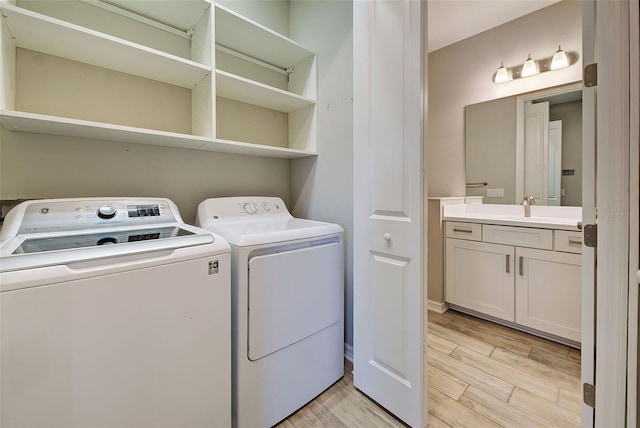 clothes washing area featuring washer and clothes dryer and sink